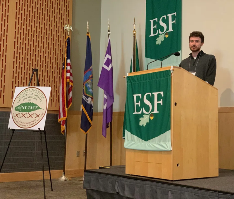 Erik Carlson speaking at a podium at SUNY ESF.