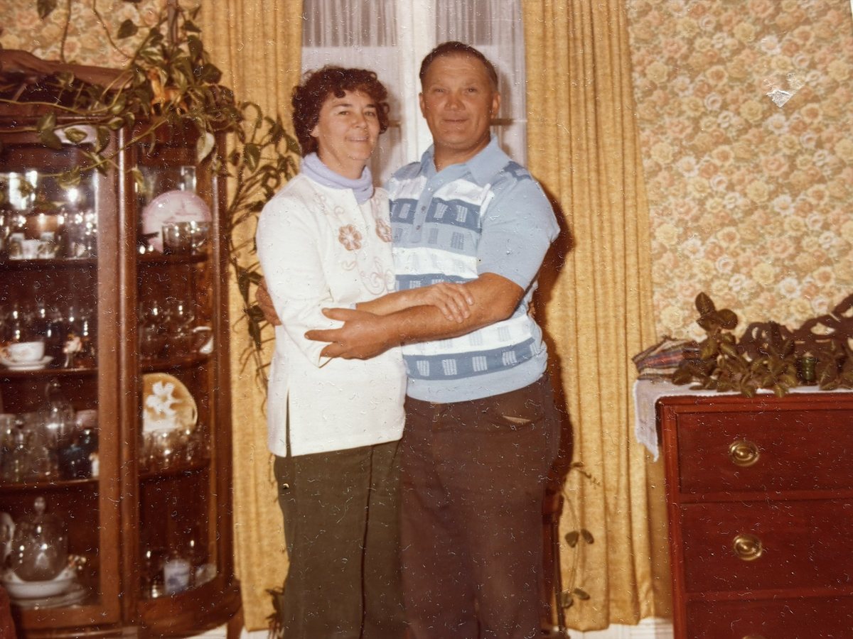Eugene and Pearl Simmons standing together indoors.